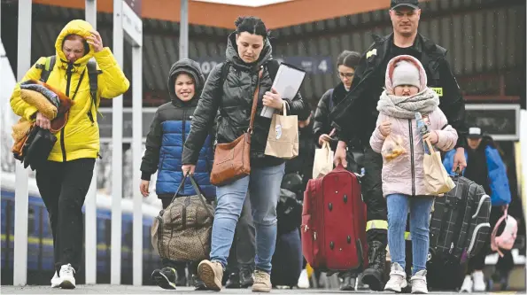  ?? JEFF J MITCHELL / GETTY IMAGES ?? Although millions of Ukrainians have fled the war, thousands are taking the train back, some saying that the situation is now safer than a few weeks ago.