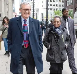  ?? ASHLEE REZIN GARCIA/SUN-TIMES ?? ABOVE: Mayor Lori Lightfoot walks out of City Hall with Corporatio­n Counsel Mark Flessner (left) on Friday.