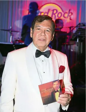  ??  ?? Tan Sri Razman Hashim with his first album, Come Swing With Me,which contains his rendition of famous crooner Frank Sinatra’s songs. — SUNWAY GROUP