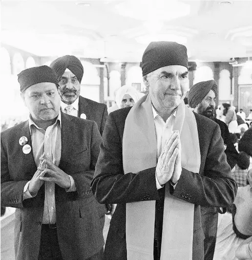  ?? Jason Franson / THE CANADIAN PRESS ?? Alberta PC Leader Jim Prentice takes part in a Sunday service at a Sikh gurdwara during a campaign stop in Edmonton.