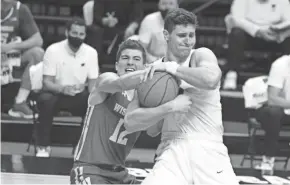  ?? AP ?? Wisconsin's Trevor Anderson, left, and Penn State's John Harrar fight for possession of the ball Saturday. Harrar had 14 of his 17 points and all eight of his rebounds in the second half as the Nittany Lions took control of the game.