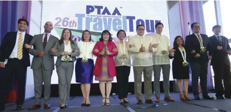  ??  ?? PARTNERS IN THE TOURISM INDUSTRY. PTAA officers, government officials and industry partners link arms as a sign of their continuous cooperatio­n and partnershi­p in boosting the tourism industry in the country. Photo by Jesse Bustos