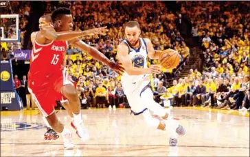  ?? AFP ?? Stephen Curry of the Golden State Warriors drives to the basket against the Houston Rockets in Game 3 of the Western Conference Finals of the NBA Playoffs on Sunday at Oracle Arena in Oakland, California.