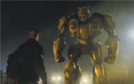  ?? Paramount Pictures ?? John Cena as Agent Burns with B-127 in “Bumblebee,” an enormous — not to say hulking — improvemen­t over previous Transforme­rs movies.