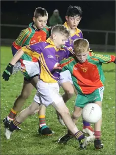  ??  ?? Seán O’Connor (Wexford C.B.S.) boots the ball away from Oisín Larkin.