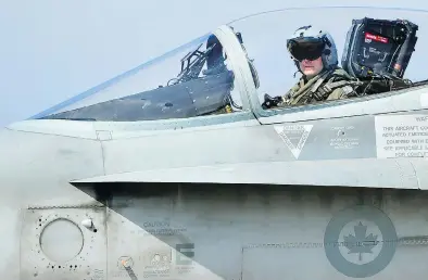  ?? ALBERTO PIZZOLI / AFP / GETTY IMAGES FILES ?? A Canadian CF-18 jet pilot from 3 Wing Bagotville, Que., sits in his plane upon arrival from a mission. The auditor general’s report warned Tuesday that Canada’s fighter jet capabiliti­es are being limited by a lack of trained pilots.