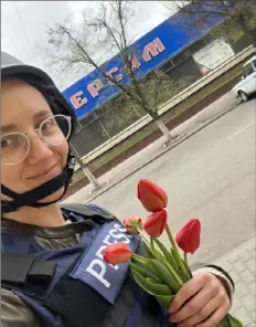  ?? ?? Ukrainian journalist and Pittsburgh Post-Gazette freelancer Tanya Kozyreva holds tulips, a symbol of new life in springtime, in the city of Slovyansk in the war zone of Donetsk, eastern Ukraine.