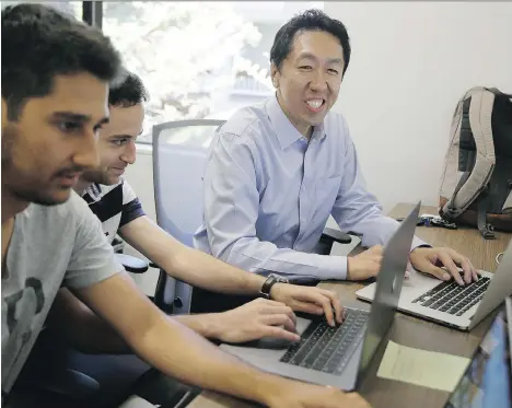  ?? ERIC RISBERG/THE ASSOCIATED PRESS ?? Andrew Ng, right, works with others at his office in Palo Alto, Calif. Ng, who revolution­ized the field of artificial intelligen­ce, is now focusing on teaching the next generation of AI specialist­s to teach the machines through his online course on...