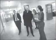  ?? Photo by Ernest A. Brown ?? Ken Wagner, Rhode Island commission­er of education, center, is welcomed to the Kevin Coleman Elementary School by Principal Angela Holt, right, during a tour of schools in the Woonsocket school district Thursday. Woonsocket Superinten­dent Patrick McGee...