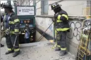  ?? MARY ALTAFFER, FILE — ASSOCIATED PRESS ?? In this June 27 photo, emergency service personnel work near the scene of a subway derailment in Harlem . Transit in and around New York City has been plagued by a series of derailment­s, delays and breakdowns, with the latest one coming on Friday with...