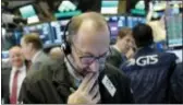  ?? MARK LENNIHAN — THE ASSOCIATED PRESS ?? Trader Edward Landi works at the New York Stock Exchange, Wednesday in New York. The major U.S. stock indexes finished mostly higher Wednesday, with small companies notching big gains as lawmakers in the House and Senate reached a deal on a sweeping...