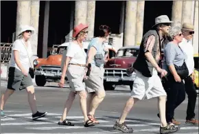  ??  ?? FOOT PATROL: Tourists walk the streets of Old Havana.