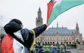  ?? Reuters ?? Having a voice: A man waves a Palestinia­n flag outside the Internatio­nal Court of Justice in the Hague. /