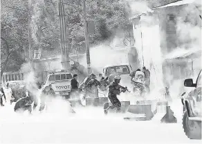  ?? AP ?? Security forces run from the site of a suicide attack after a second bombing in Kabul, Afghanista­n, on April 30.