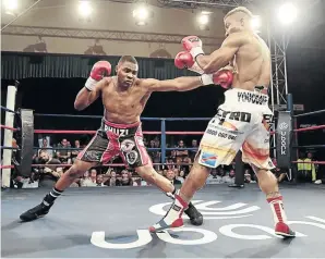  ?? / NICK LOURENS ?? Akani “Prime” Phuzi jabs Congolese Youssof Mwanza in a 12-rounder, to win the WBA Pan African cruiserwei­ght belt on Sunday.