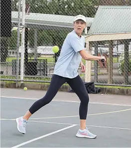  ?? ?? Below: Karen Piner’s one-handed backhand comes to the fore as she runs to get the ball back for Hallora.