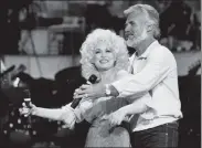  ?? AP FILE ?? Kenny Rogers, seen rehearsing a song for a 1983 TV appearance with Dolly Parton, died of natural causes at his Georgia home on Friday. He was 81.