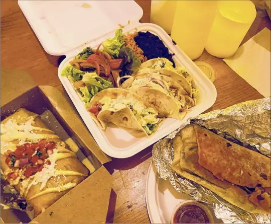  ?? Photos by Susie Davidson Powell / For the Times Union ?? Food including, from left, chimichang­as, tacos and burritos are served in takeout containers at Norte Azul Cantina in Stephentow­n.