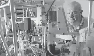  ??  ?? Dr. Barry Wood from the NRC, standing beside the NRC Kibble Balance, which is used to develop a refined value of Planck’s constant. It’s a step toward redefining the kilogram.