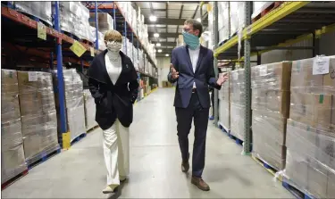  ??  ?? Claire Babineaux-Fontenot, CEO of Feeding America, and Jay Worrall, President of Helping Harvest, in the warehouse at Helping Harvest. At the Berks / Schuylkill Helping Harvest Fresh Food Bank in Spring Township Wednesday morning January 20, 2021where Claire Babineaux-Fontenot, the CEO of Feeding America. Helping Harvest is a member of Feeding America.