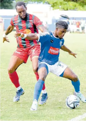  ?? ASHLEY ANGUIN ?? Mount Pleasant Football Academy’s Romeo Guthrie (right) tries to get by Montego Bay United’s Gregson President during their Wray and Nephew-sponsored Jamaica Premier League match at the Drax Hall yesterday. The game drew 1-1.