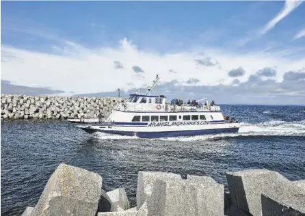  ?? Andy Haslam photos / New York Times ?? A ferry from the Irish mainland heads into Inishmaan harbor. The island of Inishmaan is less than 4 square miles. Its village consists of one shop and one bar.