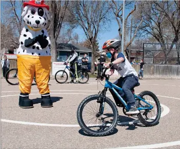  ?? SCOTT ANDERSON/SOUTHWEST BOOSTER ?? Darby Schafer negotiates the bike safety course at ACT Park this past week in helping promote Bike Safety Week on May 16 to 22.