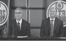  ?? POSTMEDIA NEWS ?? New Oilers GM Craig MacTavish, left, and team president Kevin Lowe listen to questions Monday in Edmonton. Lowe announced the firing of Steve Tambellini, with MacTavish replacing him.