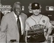  ?? Brett Coomer / Staff photograph­er ?? Jose Altuve receives the Hank Aaron Award from the former home run king during the 2017 World Series.