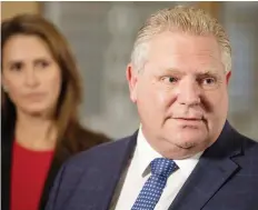  ?? CHRIS YOUNG/THE CANADIAN PRESS ?? Ontario Premier Doug Ford, flanked by Caroline Mulroney, the minister responsibl­e for francophon­e affairs, speaks to media after his meeting with Quebec Premier François Legault.