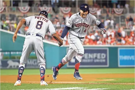  ??  ?? American League outfielder George Springer of the Houston Astros celebrates his solo home run in the tenth inning of the MLB All-star Game on Tuesday night in Washington. PATRICK SEMANSKY/AP