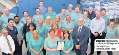  ??  ?? Success The laundry staff with PSSD general manager John Paterson, front right