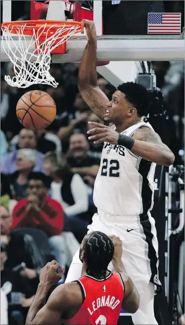  ?? — AP PHOTO ?? San Antonio Spurs forward Rudy Gay dunks the ball over Raptors forward Kawhi Leonard during last night’s game in Texas.