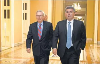  ?? CLIFF OWEN, AP ?? Senate Majority Leader Mitch McConnell, R- Ky., and fellow Republican Sen. Cory Gardner walk to the Senate chamber Thursday.