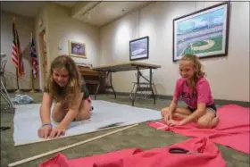  ?? ERIC BONZAR — THE MORNING JOURNAL ?? Eleven-year-old Emma Campbell, left, and Mallory Reynolds, 12, work on their tied fleece blankets during the Avon Lake Library’s Craft + Lunch = Crunch program July 26. As part of the Library’s summer reading program, children between the ages of 10...