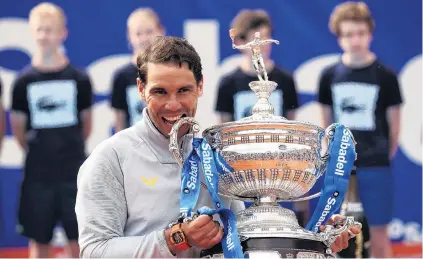  ?? PHOTO: REUTERS ?? King of clay . . . Spaniard world No 1 Rafael Nadal celebrates with the trophy after winning the final against Greek Stefanos Tsitsipas 62, 61 yesterday to claim his 11th Barcelona Open.