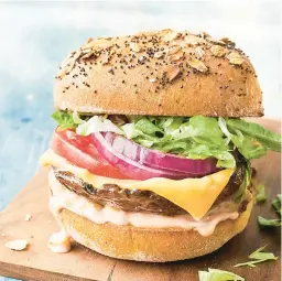  ?? GREG DUPREE/EATINGWELL ?? Portobello mushrooms stand in for meat patties in this recipe for veggie burgers with all the fixings.