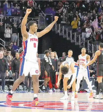  ?? CARLOS OSORIO AP ?? Pistons center Jalen Duren (0) and Cade Cunningham react after defeating the Raptors to end their skid.