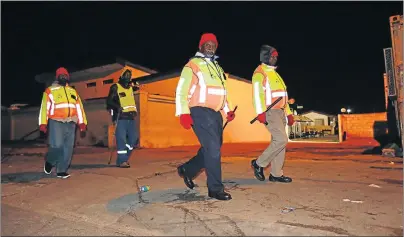  ?? Picture: WERNER HILLS ?? SAFETY FIRST: Siyakhatha­la Community Forum members patrol the streets of New Brighton every morning. Here forum members patrol in Ferguson Street