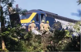  ?? DEREK IRONSIDE/NEWSLINE-MEDIA VIA AP ?? Emergency services attend the scene of a derailed train in Stonehaven, Scotland, on Wednesday.