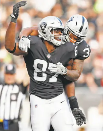  ?? Scott Strazzante / The Chronicle ?? Raiders tight end Jared Cook (87) celebrates his 24-yard touchdown catch with DeAndre Washington in the third quarter against the Chiefs. Cook had seven receptions for 100 yards.