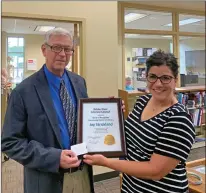  ?? SUBMITTED ?? Gia Taylor, vice president of the White River Literacy Council, presents Jay Strickland of the University of Arkansas Community College at Batesville with the council’s 2020 Community Person in Literacy award.