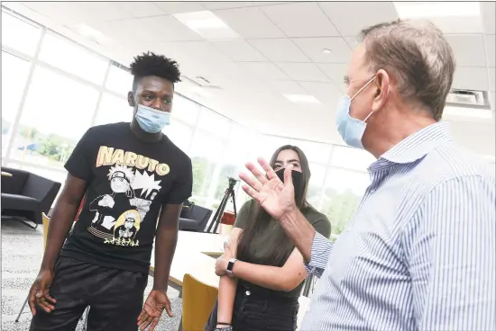  ?? Arnold Gold / Hearst Connecticu­t Media ?? From left, Joshua Ofori- Attah and Lauren Panza speak with Gov. Ned Lamont after a meeting at West Haven High School on Friday.