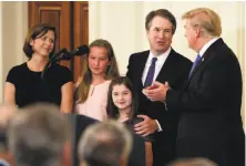  ?? Evan Vucci / Associated Press ?? President Trump greets Brett Kavanaugh and his family at the White House on July 9, the day Trump announced his nomination to fill Justice Anthony Kennedy’s seat on the Supreme Court.
