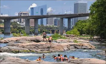  ?? Matt McClain /The Washington Post ?? People cool off in the James River at Belle Isle on Sunday, July 19, 2020, in Richmond, Va.