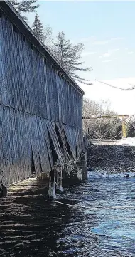  ?? HO, DEBBIE MCCANN / THE CANADIAN PRESS ?? The historic covered Bell Bridge in Hoyt, N.B., was damaged by the flooding and is not salvageabl­e.