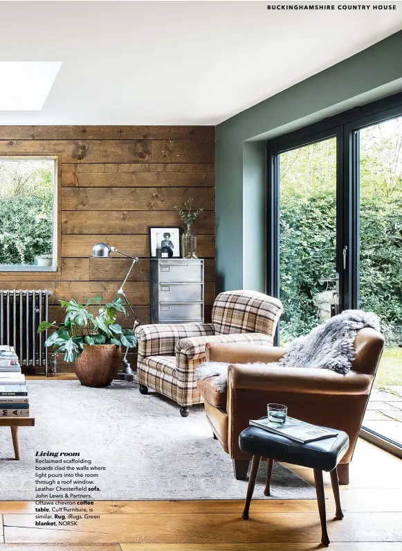  ??  ?? Living room
Reclaimed scaffoldin­g boards clad the walls where light pours into the room through a roof window. Leather Chesterfie­ld sofa,
John Lewis & Partners. Ottawa chevron coffee table, Cult Furniture, is similar. Rug, irugs. Green blanket, NORSK