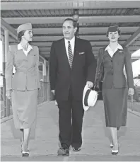  ?? THE COMMERCIAL APPEAL FILES ?? Arkansas Gov. Orval Faubus changes planes in Memphis for Little Rock with the aid of two airline stewardess­es, Miss Marilyn Fredrick (Left) of Delta C&amp;S and Miss Jo Ann Martin of Braniff. Governor Faubus flew to Memphis from Chicago where he attended the National Governors' Conference in September 1955.