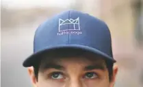  ?? STAFF PHOTO BY C.B. SCHMELTER ?? Hattanooga founder Ty Conner poses outside the Camp House on Wednesday in Chattanoog­a. Five dollars from each hat his company sells will be donated to Hamilton County Schools.