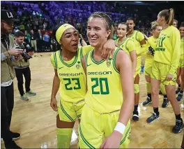  ?? JOHN LOCHER – THE ASSOCIATED PRESS ?? Oregon’s Minyon Moore, left, and Sabrina Ionescu walk off after defeating Arizona in a Pac-12tourname­nt semifinal last week. The Ducks beat Stanford a day later in the final.